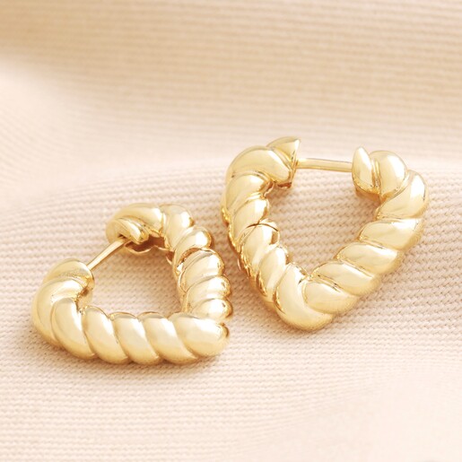 Twisted Rope Creole Heart Hoop Earrings In Gold Twisted Rope Creole Heart Hoop Earrings In Gold on beige Fabric