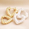 Twisted Rope Creole Heart Outline Hoop Earrings In Silver and Gold on Beige Fabric