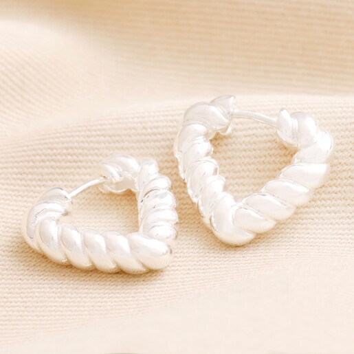 Twisted Rope Creole Heart Outline Hoop Earrings In Silver on Beige Fabric