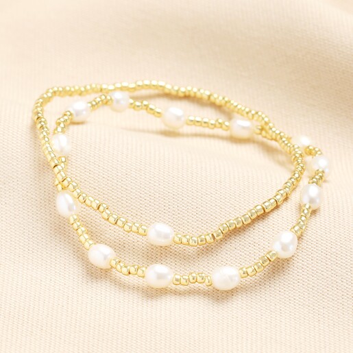 Set of 2 Freshwater Pearl Beaded Bracelets in Gold on a neutral background