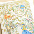 The Art File Merry Unbirthday Storybook Card on neutral background close up