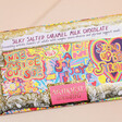 Close up of Front illustration of Arthouse Unlimited Full of Joy Silky Salted Caramel Milk Chocolate Bar on a neutral background