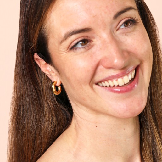 Model Shot Model Shot of Stainless Steel Molten Hammered Hoop Earrings in Gold