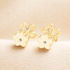 Delicate Outline Flower Stud Earrings in Gold with Flower Backs on a neutral background