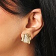 Driftwood Style Ridged Stud Earrings in Gold on an ear