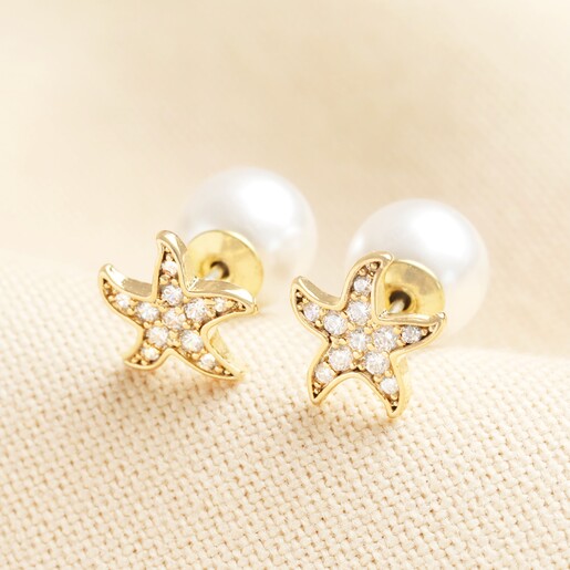 Cubic Zirconia Starfish Stud Earrings with Pearl Backs on a neutral background