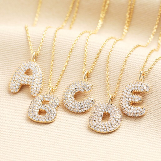 Initial Diamante Pendant Necklace in Gold Bubble letter initial pendants in gold encrusted with cubic zirconas.