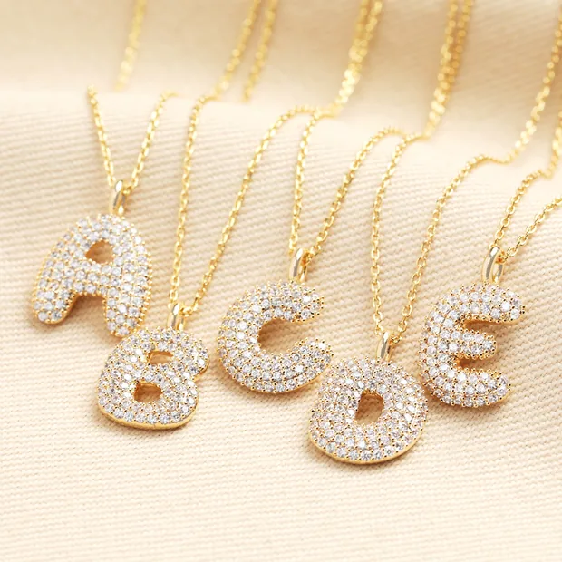 Initial Diamante Pendant Necklace in Gold Bubble letter initial pendants in gold encrusted with cubic zirconas.