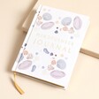 A light purple journal with a shell pattern