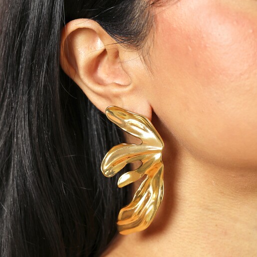 Big Metal London Floral Stainless Steel Earrings in Gold on a neutral cream background on a model