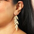 Big Metal London Long Leaf Dangle Earrings Gold on a model