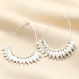 A pair of silver teardrop-shaped earrings