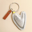 A silver heart keyring with a metal split ring