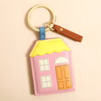 A pink and yellow house-shaped keyring