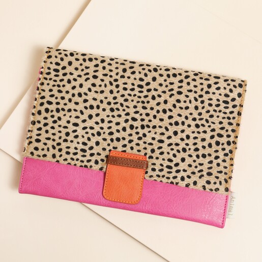 A vegan leather travel wallet with orange accents