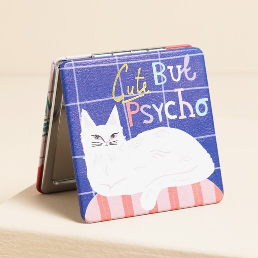 A compact pocket-sized mirror with a cat design