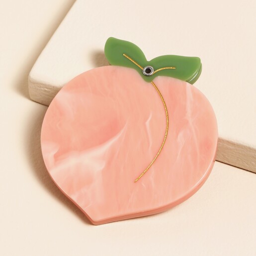 A cheeky and fun fruit-shaped compact mirror