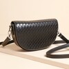 A sleek and stylish half-moon crossbody bag