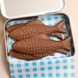 Inside fof The Chocolate Gift Company Perfect Catch Milk Chocolate Sardines with checked blue paper