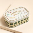 A French-themed sardine tin-inspired candle