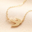 Close up of Flying Bird Pendant Necklace in Gold
