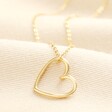 Stainless Steel Organic Shape Heart Outline Pendant Necklace in Gold on a neutral background