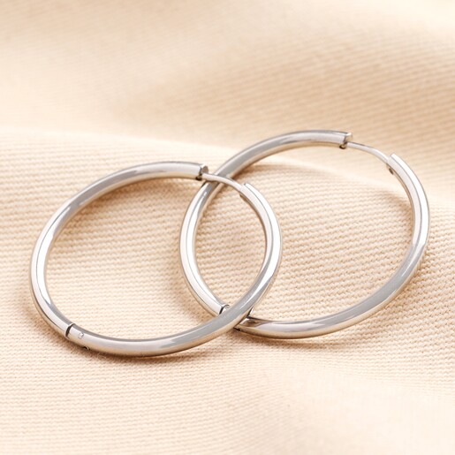 Stainless Steel Slim Hoop Earrings in Silver on neutral background
