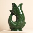 A medium ceramic gurgle jug in dark green