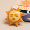 Close up of Tiny Matchbox Ceramic Sunshine Token 