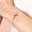 Close Up Model Shot of Adjustable Opal Bee Open Bangle in Gold on Model