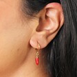 Close Up Model Shot of Red Chilli Huggie Hoop Earrings in Gold