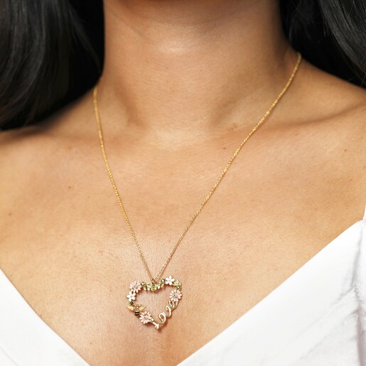 Model Shot of Crystal Flower and Bee 'Love' Pendant Necklace in Gold