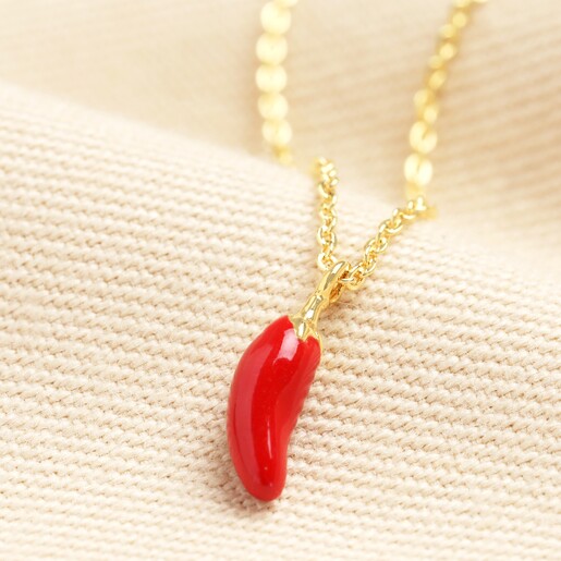 Red Chilli Pendant Necklace in Gold on beige material background