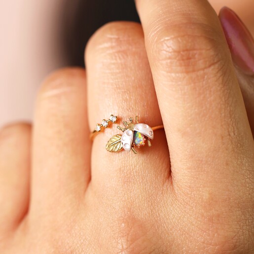 Close Up Model Shot of Adjustable Opal Ladybird Ring in Gold