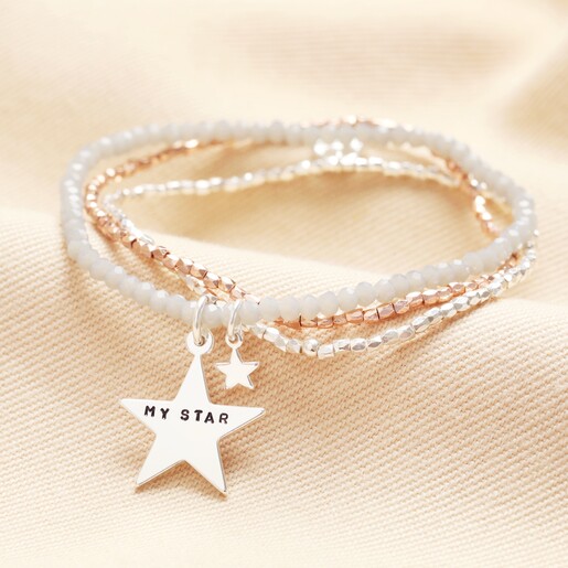 Close up Personalised Mixed Metal Star Charm Multi Layer Beaded Bracelet on neutral background