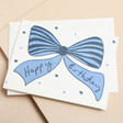 Heather Evelyn Birthday Blue Bow Card on neutral background