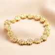 Flower Beaded Bracelet in Gold on beige material background