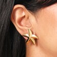 Close Up of Stainless Steel Large Starfish Stud Earrings in Gold on Model