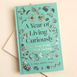 A Year of Living Curiously Book on a neutral background