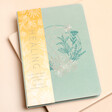 Healing Reflective Journal with floral details on a neutral background