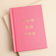 A self-care guide with a pink cover