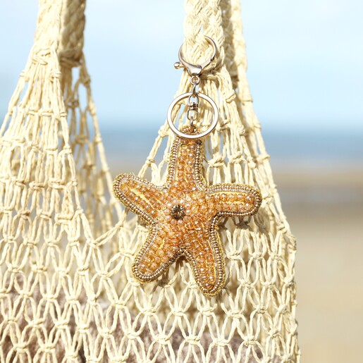 Beaded Starfish Keyring and Bag Charm on a Beige Background