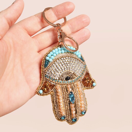 Model holding Beaded Hamsa Hand Keyring and Bag Charm