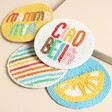 A set of four colourful coasters with bold designs