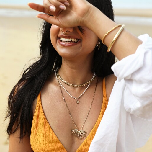 Stainless Steel Chevron Chain in Gold on a Beige Background Stainless Steel Chevron Chain in Gold on a Beige Background