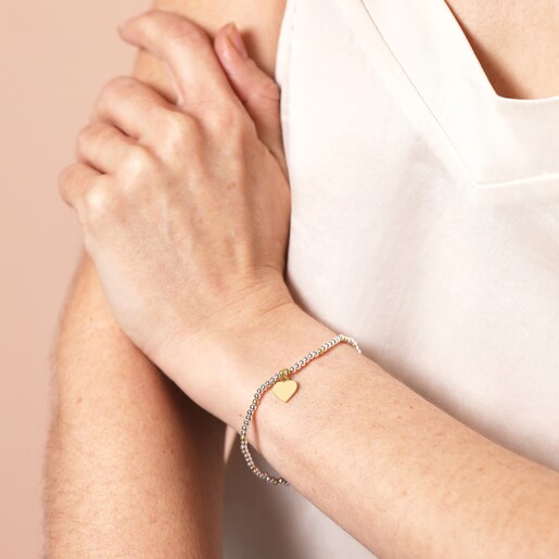 Gold and Silver Beaded Heart Charm Bracelet on a model