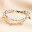 Purple and Blue Cord Double Layer Beaded Bracelet in Gold on a neutral background