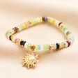 eaturing semi-precious beads in red, pink, green, white, blue, yellow and gold, this stunning bracelet includes a gold plated sun charm with hammered texturing.