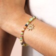 Close Up of Semi Precious Beaded Sun Charm Bracelet in Gold on Model