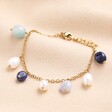 With several cool-toned semi-precious dangling beads, this bracelet also features a range of freshwater pearl charms.